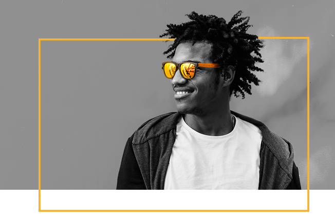 A smiling Cash Converters team member wearing yellow sunglasses